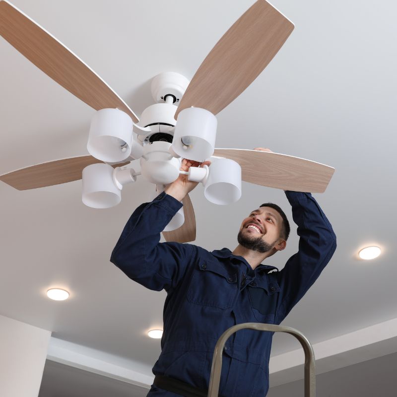 Technician installing a ceiling fan