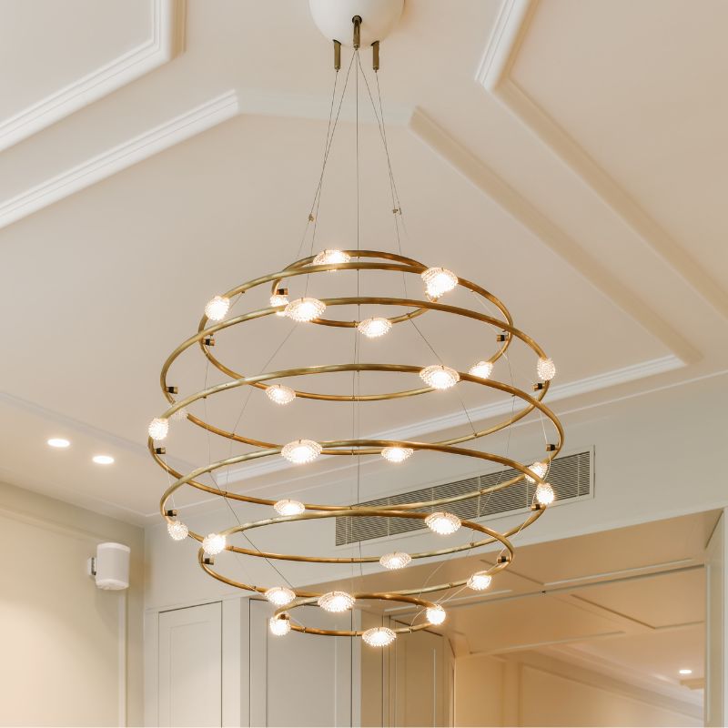 Modern lighting fixture featuring a spiraled metal design dotted with bulbs