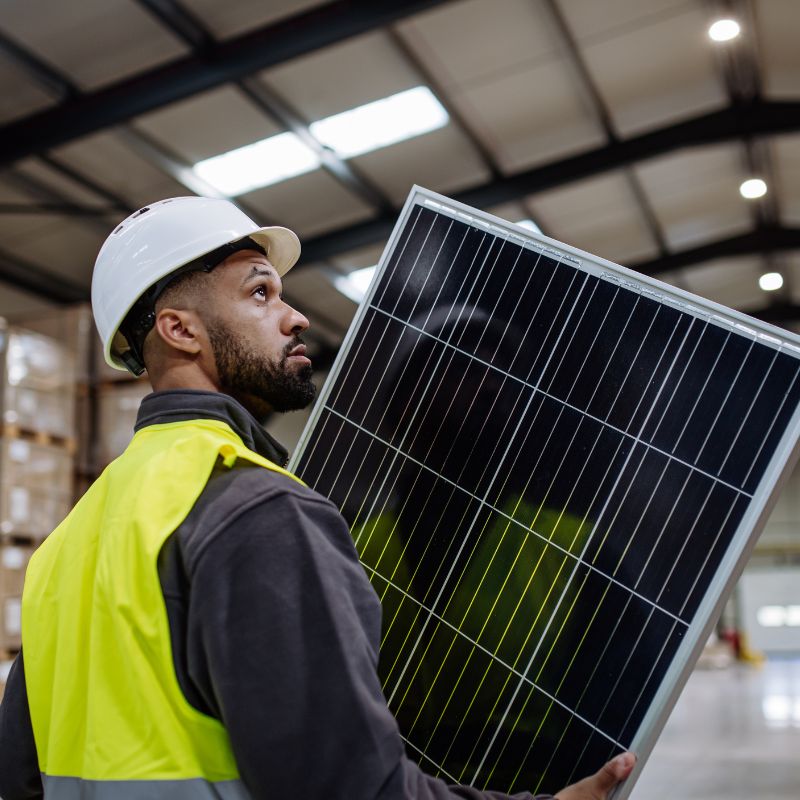 Technician holding solar panel