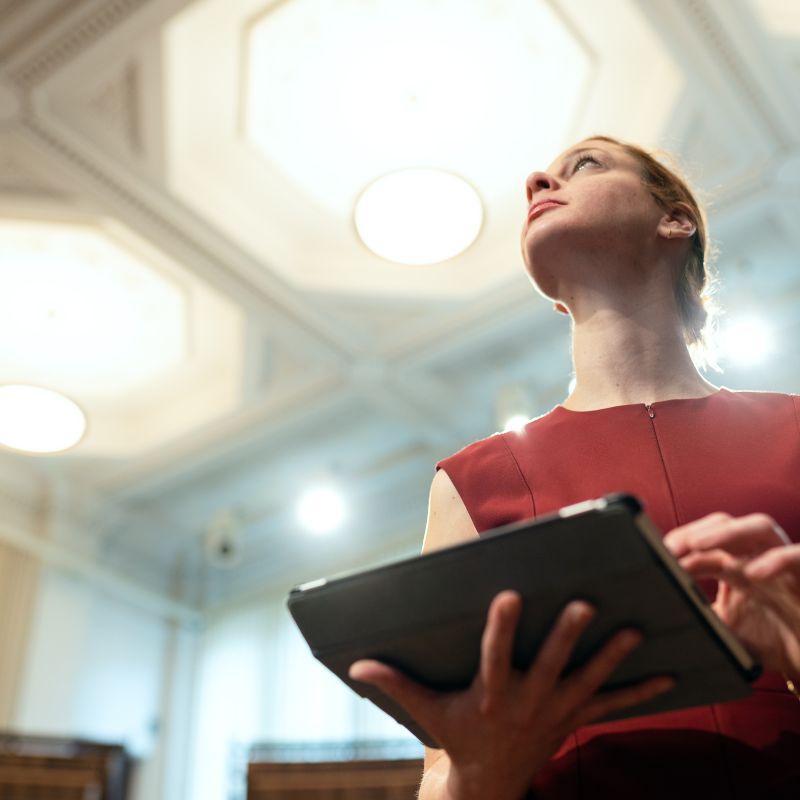 Woman adjusting lights with a digital tablet