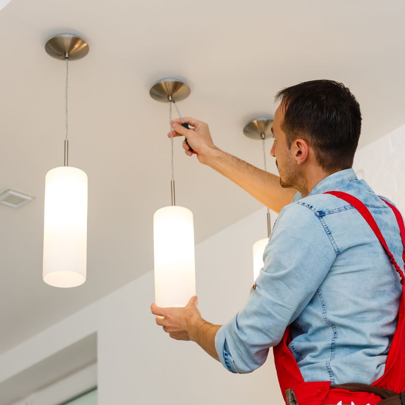 Electrician installing pendant lights