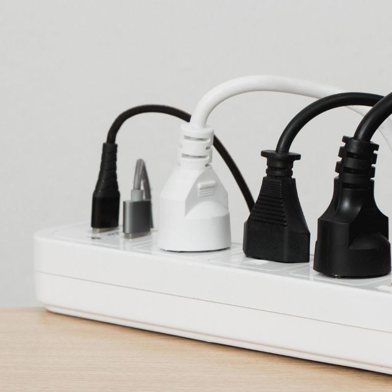 An extension cord with multiple devices plugged in