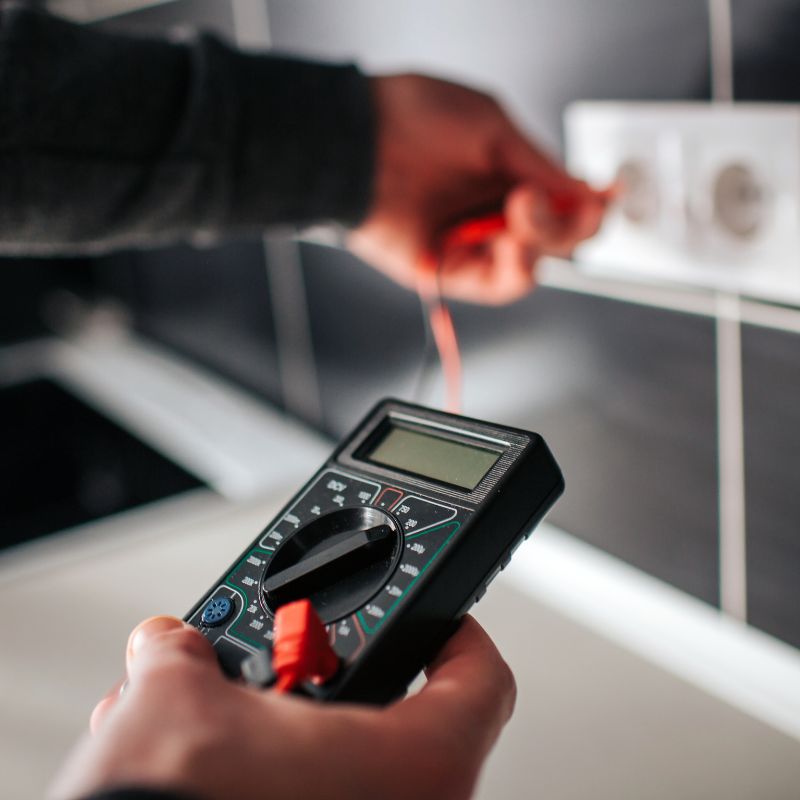 An electrician testing an outlet