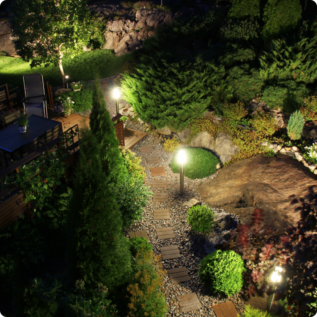 Garden lights highlighting flowerbeds and small shrubs, adding depth to garden landscaping