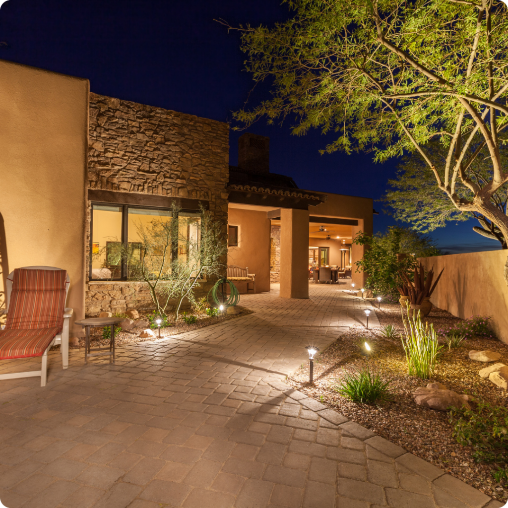 Charming outdoor landscape lighting illuminating a walkway in front of a house