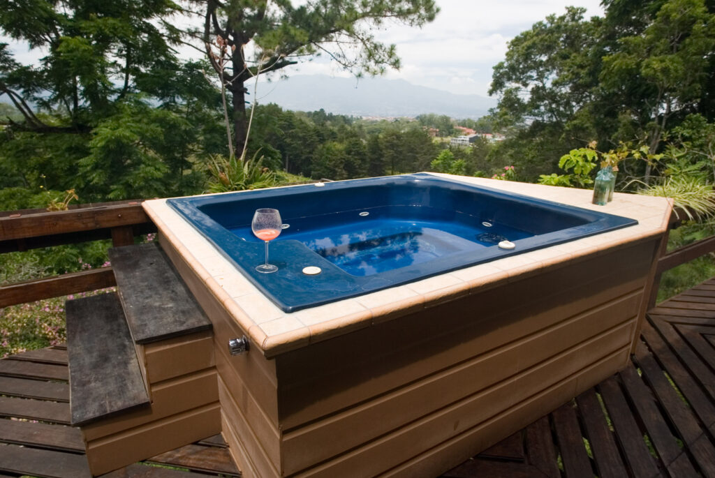 hot tub in a jungle looking backyard