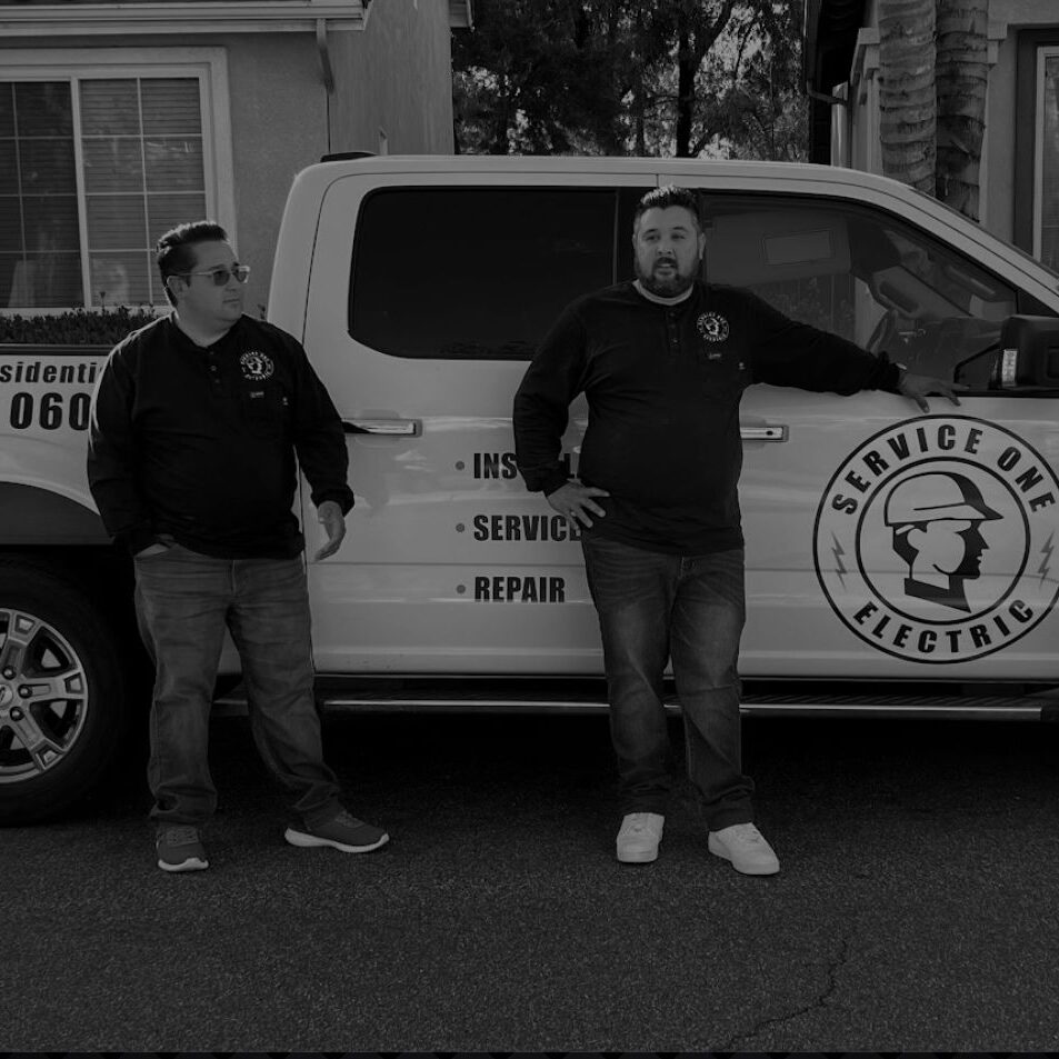 service one electric team posing in front of work truck